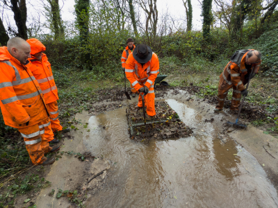 Digging out of catchment pit and clearing of culvert inlet grid in progress. Embankment of the trackbed behind. Day 3 November Work Weekend.